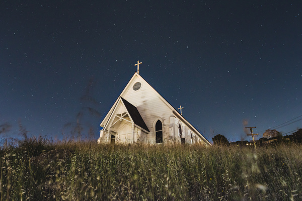 church on grassland at dusk Stock Photo