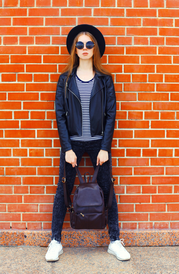 girl with a backpack wearing sunglasses Stock Photo