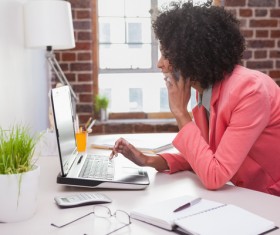 woman on the phone uses laptop Stock Photo