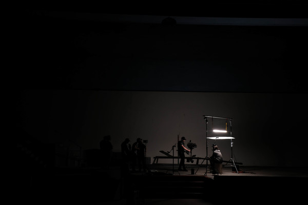 Artists performing on dark stage Stock Photo