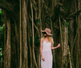 Beautiful girl taking photos near old trees Stock Photo