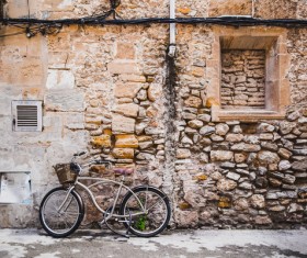 Bicycle leaning against old brick house Stock Photo