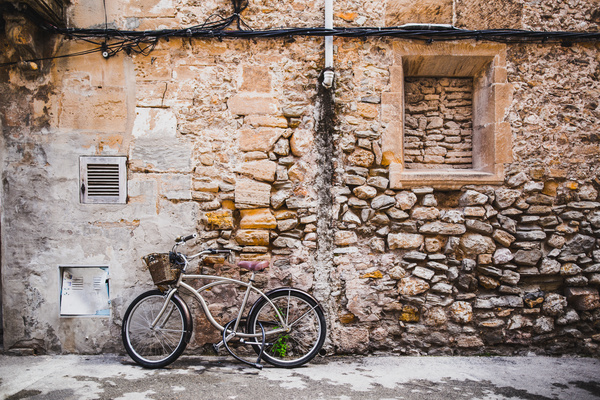 Bicycle leaning against old brick house Stock Photo