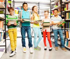 Children holding books in the library Stock Photo