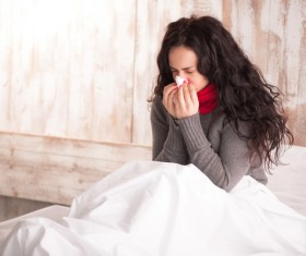 Colds Woman resting in bed Stock Photo