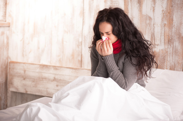 Colds Woman resting in bed Stock Photo
