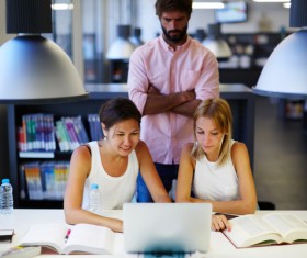 College students using laptop in the library Stock Photo