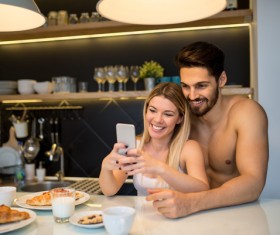 Couple using smart phone selfie at the table Stock Photo