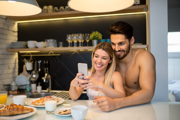 Couple using smart phone selfie at the table Stock Photo