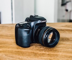 Digital camera on wooden table Stock Photo