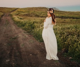 Elegant woman takes pictures on dirt roads Stock Photo