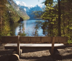 Empty wooden bench on tranquil lake landscape Stock Photo