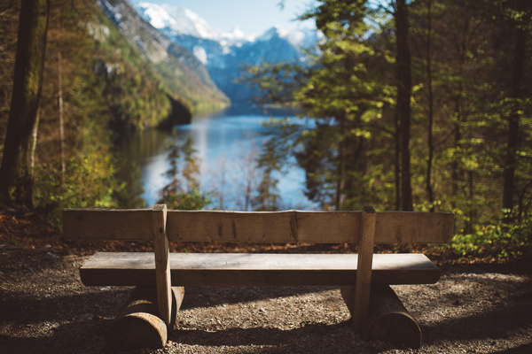 Empty wooden bench on tranquil lake landscape Stock Photo