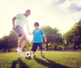 Father and son playing football Stock Photo
