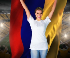 Female football fan holding the flag Stock Photo