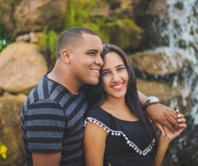 Happy couple posing near waterfall Stock Photo