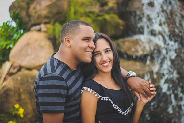 Happy couple posing near waterfall Stock Photo