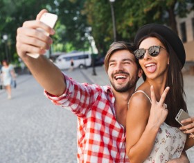 Lovers using smart phone selfie funny face Stock Photo