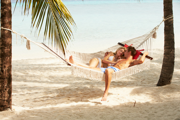 Loving couple on the beach hammock Stock Photo