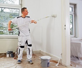 Man brushing the wall Stock Photo