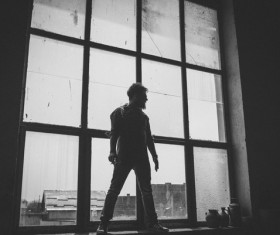 Man posing near glass window Stock Photo