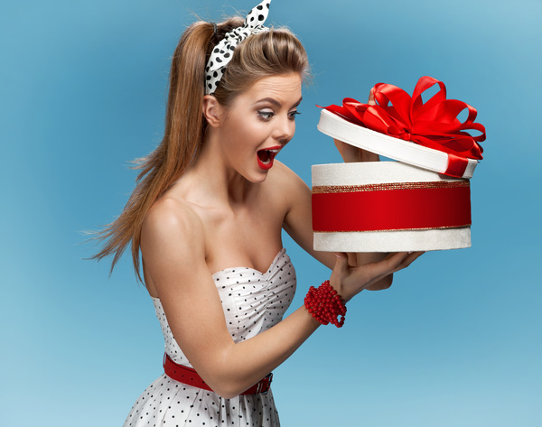 Open gift box surprised woman Stock Photo