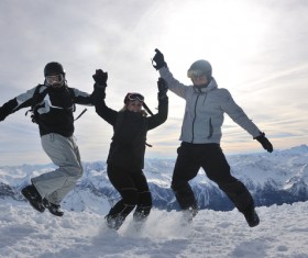 People jumping happily on the snow Stock Photo