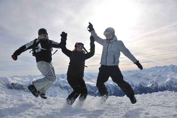 People jumping happily on the snow Stock Photo