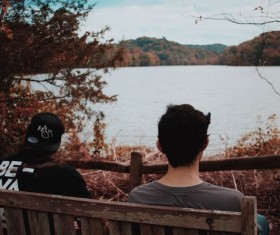 People sitting on the bench by the lake Stock Photo