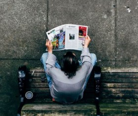 People who read newspapers on the bench Stock Photo