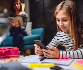 Pupils playing smartphones Stock Photo