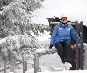 Rest skier sitting on the fence Stock Photo