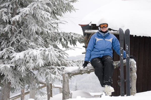 Rest skier sitting on the fence Stock Photo