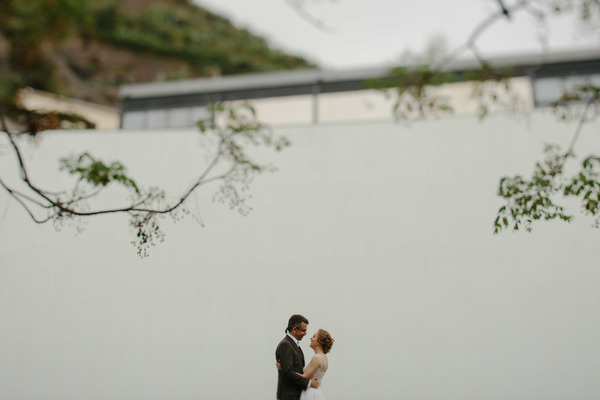 Romantic marriage couple posing near white wall Stock Photo