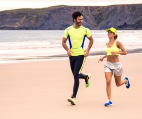 Running Lovers on the beach Stock Photo