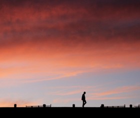 Shade of lonely man at dusk Stock Photo
