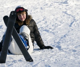 Ski girl resting on the snowy road Stock Photo