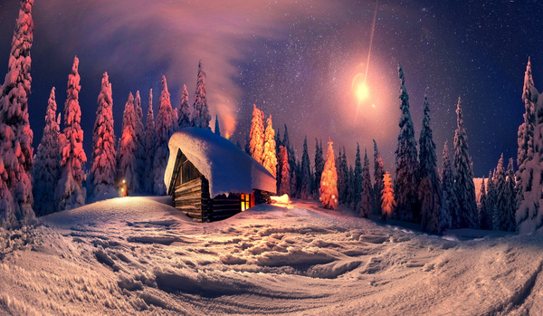 Snow-covered cottage in the forest Stock Photo