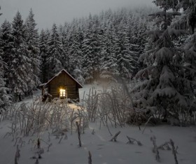 Snow-covered cottage in the forest Stock Photo
