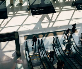 Station pedestrians and escalators Stock Photo