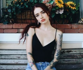 Tattoo girl sitting in front of the window Stock Photo