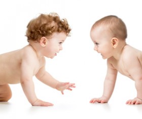 Two crawling babies Stock Photo
