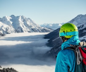 Watching the distant snow-capped mountain climbing men Stock Photo