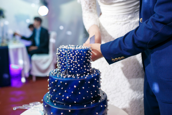 Wedding couple cutting wedding cake Stock Photo