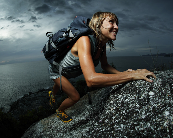 Woman climbing by hand Stock Photo