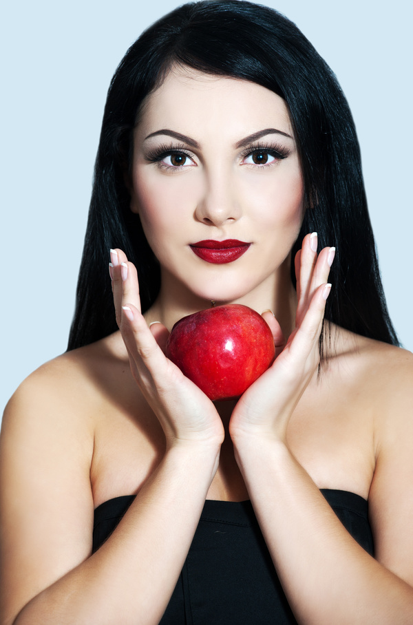 Woman holding a red apple Stock Photo