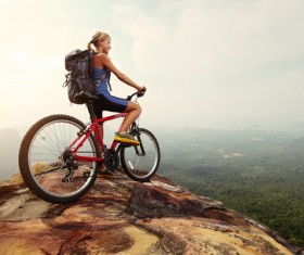 Woman riding a mountain bike looks into the distance Stock Photo 01