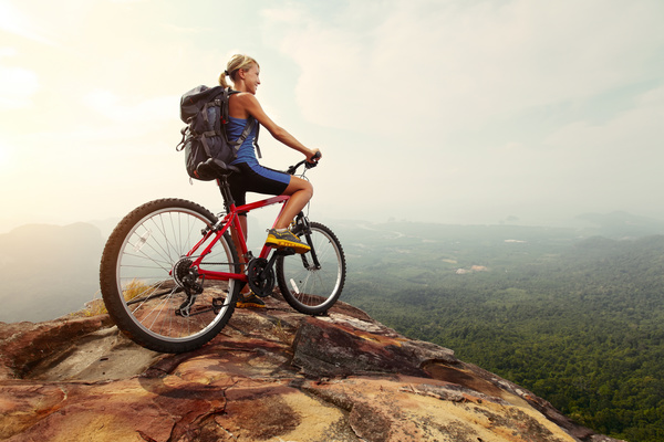Woman riding a mountain bike looks into the distance Stock Photo 01