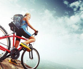 Woman riding a mountain bike looks into the distance Stock Photo 02