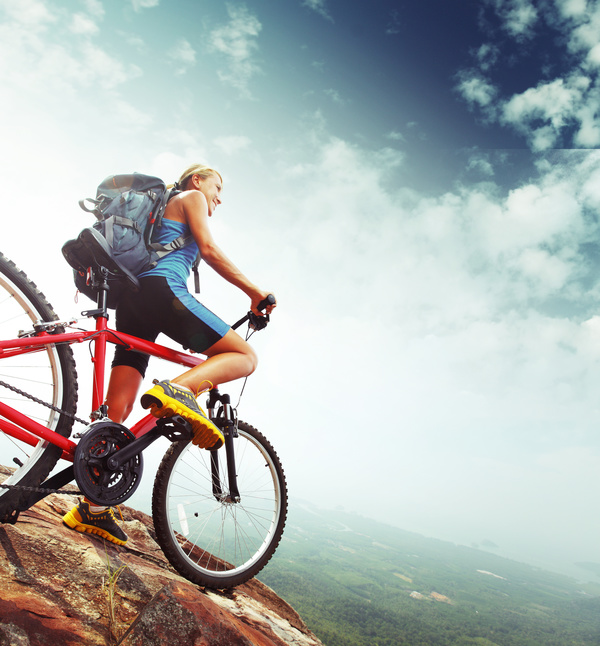 Woman riding a mountain bike looks into the distance Stock Photo 02